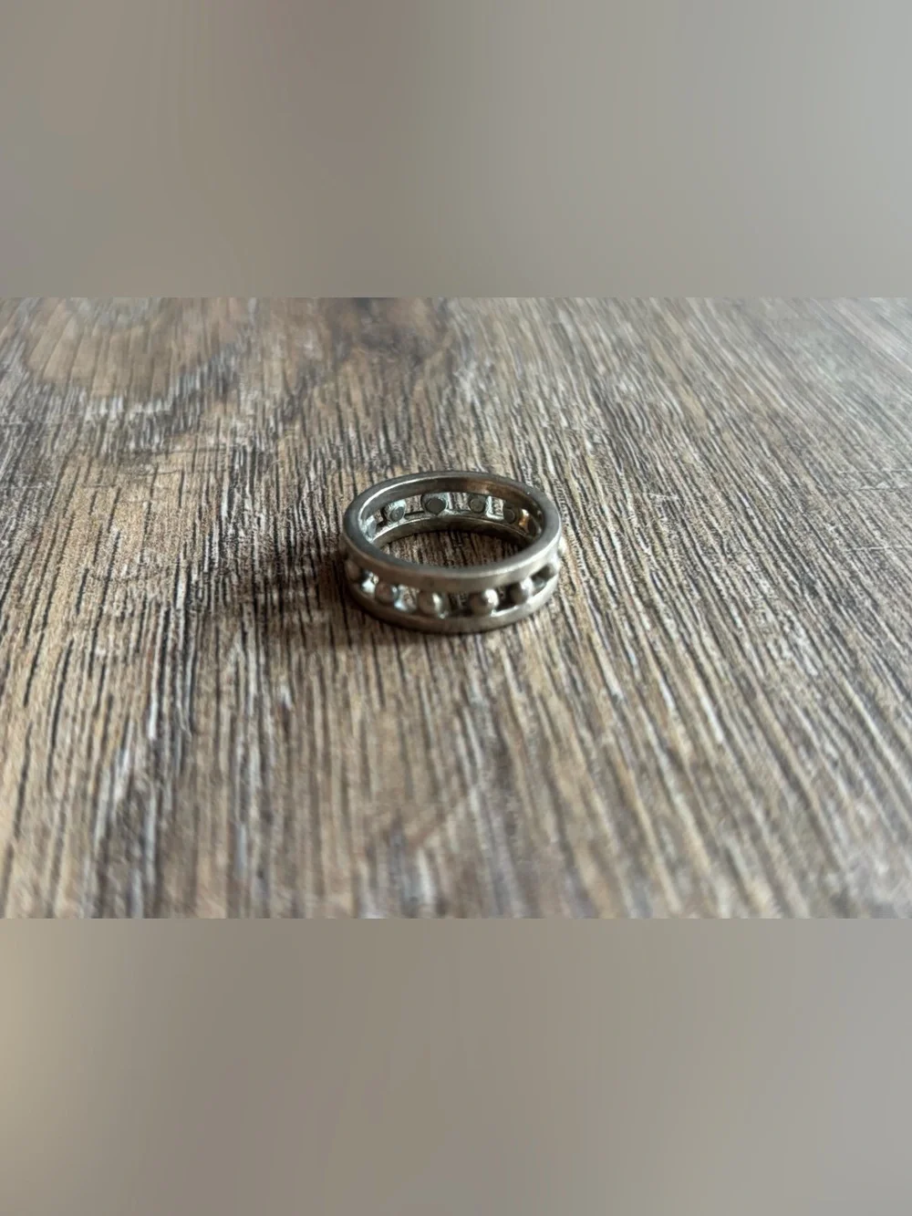 Women’s size 11.5 silver-toned metal ball bearing or studded channel band ring
